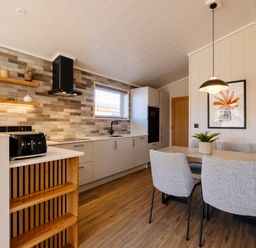 A kitchen with dining table and chairs at Luxury Boutique Retreat Pet in Waltham