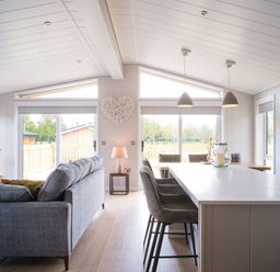A living room with a sofa and kitchen island at Marrakech in Waltham