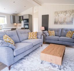 A living room with grey sofas and a wooden coffee table at Marrakech in Waltham