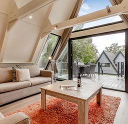 A living room with a couch and coffee table at St Ives Studio Spa in Praze-An-Beeble