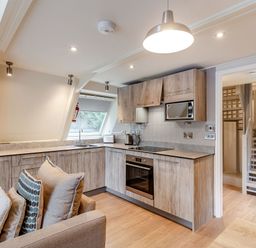 A kitchen with cabinets, sink, and appliances at St Ives Studio Spa in Praze-An-Beeble