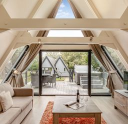 A living room with a sofa and coffee table at St Ives Studio Spa in Praze-An-Beeble