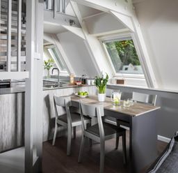 A kitchen with a table and chairs at St Ives Lodge 2 Spa Praze-An-Beeble