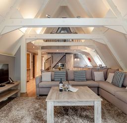 A living room with a sofa and TV at St Ives Lodge 3 Spa in Praze-An-Beeble