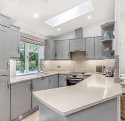 A kitchen with cabinets and a countertop at Aubyn Lodge Spa in Praze-An-Beeble