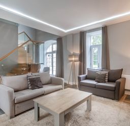 A living room with two sofas and a coffee table at Coach House in Praze-An-Beeble