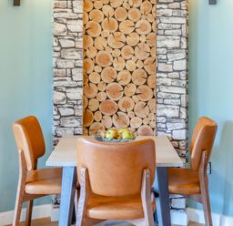 A dining room with a table and chairs at The Treehouse in Praze-An-Beeble