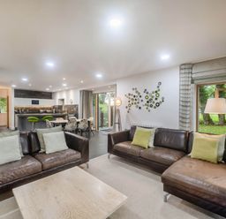 A living room with sofas and a dining area at St Austell Lodge Spa in Praze-An-Beeble