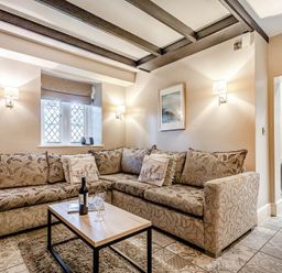 A living room with a sofa and coffee table at The Gatehouse in Praze-An-Beeble