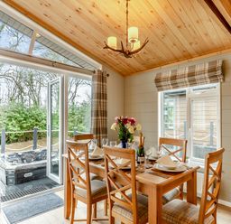 A dining room with a table set for dinner at Argel Spa in Praze-An-Beeble
