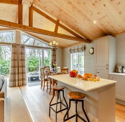 A kitchen with a dining area and sofa at Argel Spa Pet in Praze-An-Beeble