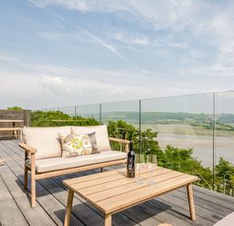 A terrace with outdoor furniture and a view at The View in Laugharne
