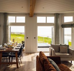 A dining room with a table and chairs at Apex Spa in Laugharne