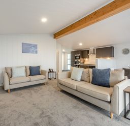 A living room with a sofa and coffee table at Sonnet 3 Spa (Pet) (Roof Terrace) in Laugharne