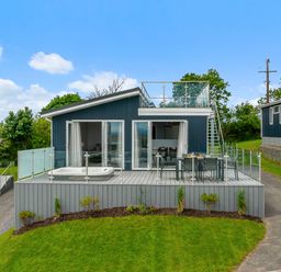 A house with a deck and hot tub at Sonnet 3 Roof Terrace Spa Laugharne