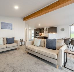 A living room with sofas and a dining area at Sonnet 3 Roof Terrace Spa Laugharne