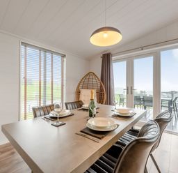 A dining room with a table and chairs at Sonnet 3 Laugharne