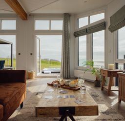 A living room with a coffee table and sofa at Apex Spa (Pet) in Laugharne