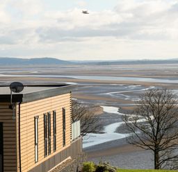 An exterior view of a building overlooking a coastal landscape at Solace in Laugharne