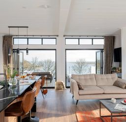 A living room with a sofa and coffee table at Solace in Laugharne