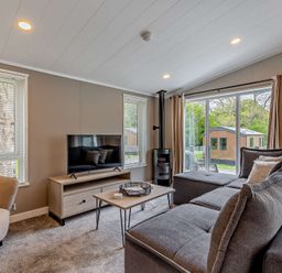 A living room with a sofa and television at Saron 2.0 Pet in Llandyrnog
