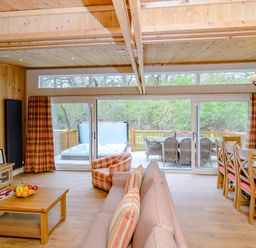 A living room with a sofa and dining area at The Fotheringhay (Pet) Kings Cliffe