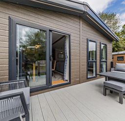 An outdoor area with seating and a table at Saron 2.0 Spa Pet in Llandyrnog