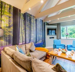 A living room with a sofa and chairs at The Whitbarrow Den in Penrith