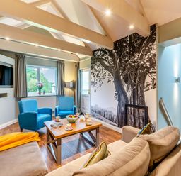 A living room with a tv and coffee table at The Whitbarrow Den Penrith