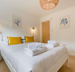 A bedroom with a bed and bedside table at Klys 1.0 Spa in Perranporth