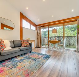 A living room with a sofa and a table at Piran Spa Lodge Pet in Perranporth