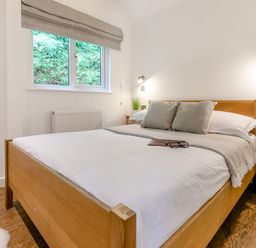 A bedroom with a bed and window at Tremewan Spa Pet Perranporth