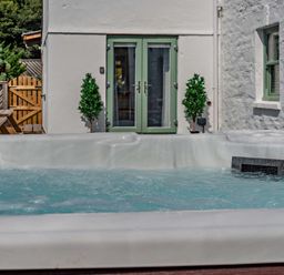 A hot tub and outdoor furniture at The Farmhouse (Pet) Perranporth
