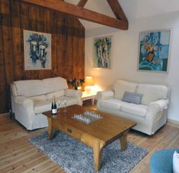 A living room with a sofa and coffee table at Nethercote Byre Minehead
