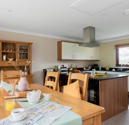 A kitchen with dining table and chairs at The Derwent in Slaley