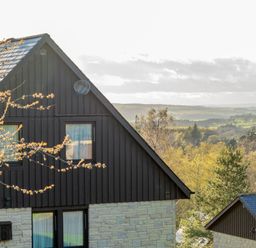 A view of a house with windows and trees at The Hexham in Slaley