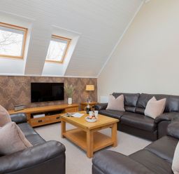 A living room with a sofa and a coffee table at The Hexham in Slaley