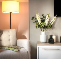 A living room with an armchair and a side table at The Hexham Spa in Slaley