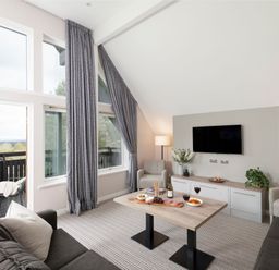 A living room with sofas and a coffee table at The Hexham Spa in Slaley