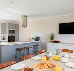 A kitchen with an island counter and dining table at The Hexham Spa in Slaley