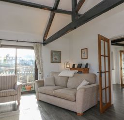 A living room with a sofa and armchair at Long Linney in Bideford