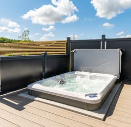 A hot tub on a wooden deck at The Oasis in Great Ayton