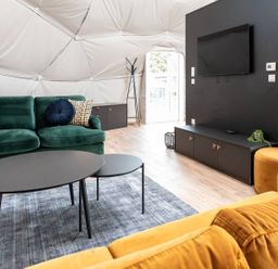 A living room with a green sofa and black coffee table at The Dome in Great Ayton