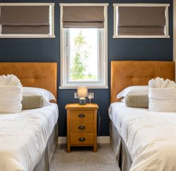 A bedroom with two beds and a nightstand at Rosedale in Great Ayton