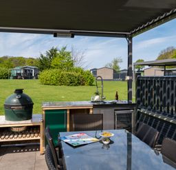 An outdoor dining area with a grill and a table at Leven (Pet) Great Ayton