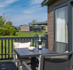 An outdoor seating area with a table and chairs at Leven (Pet) in Great Ayton