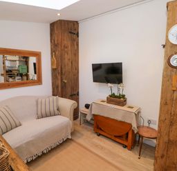 A living room with a sofa and television at Flat 4 in Evesham