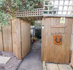 A gated entryway with a sign labeled Flat 4 at Flat 4 in Evesham