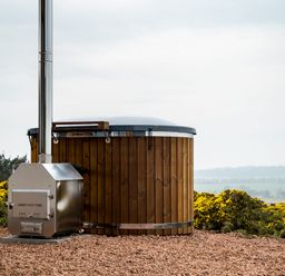 A hot tub with a chimney in a landscape at The Grays in North Berwick