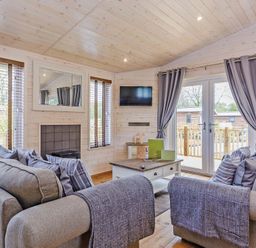A living room with a sofa and television at Hurricane Lodge in Fair Oak